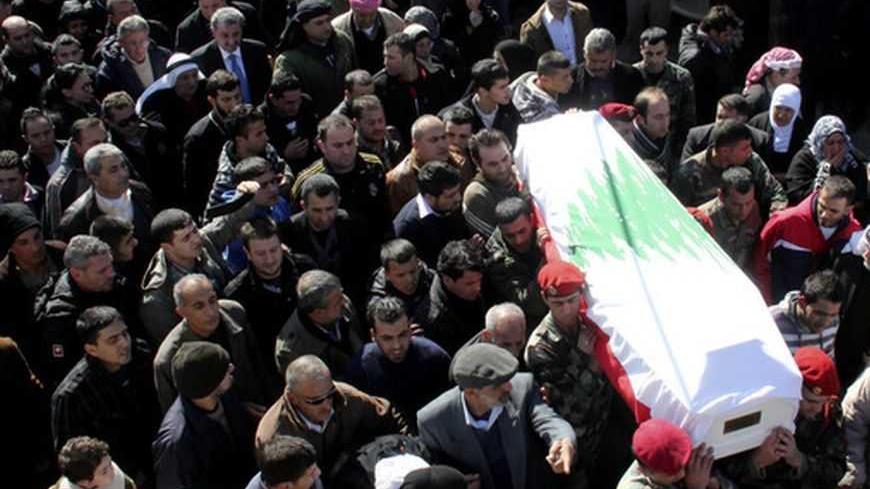 Lebanese soldiers carry the coffin of Sergeant Ibranim Zahraman during his funeral in the town of Akkar northern Lebanon February 2, 2013. Four Lebanese soldiers and two gunmen were killed in clashes in the country's Bekaa Valley on Friday after militants attacked a Lebanese army unit, security sources said. REUTERS/Stringer (LEBANON - Tags: CIVIL UNREST MILITARY POLITICS) - RTR3D9I8