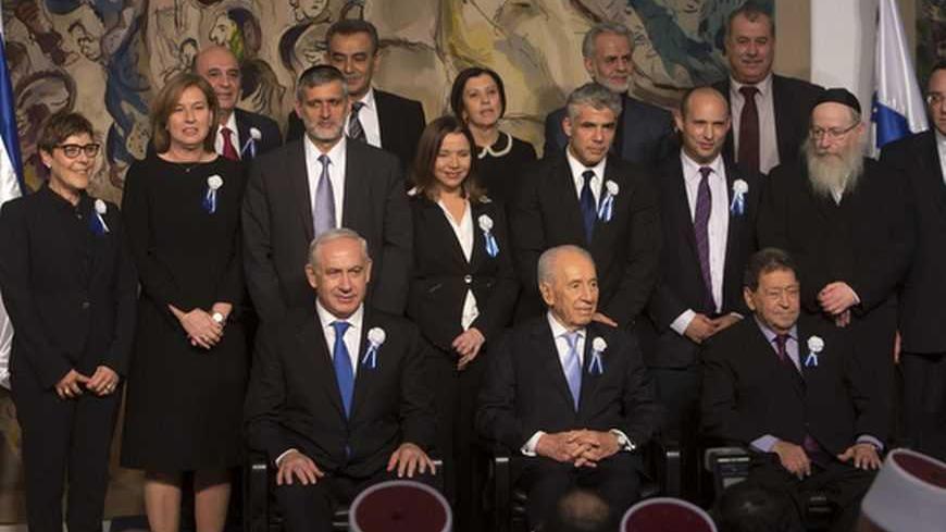 Israel's President Shimon Peres (C, seated) sits between Prime Minister Benjamin Netanyahu (L, seated) and Labour party lawmaker Binyamin Ben-Eliezer (R, seated) as party leaders of the 19th Knesset, the new Israeli parliament, pose for a group photo at a reception following their swearing-in ceremony in Jerusalem February 5, 2013. REUTERS/Ronen Zvulun (JERUSALEM - Tags: POLITICS) - RTR3DE0A