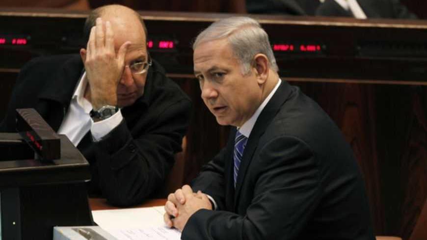 Israel's Prime Minister Benjamin Netanyahu (R) sits next to Vice Prime Minister Moshe Yaalon during a memorial service for the late Israeli Tourism Minister Rehavam Zeevi at the Knesset, the Israeli parliament, in Jerusalem November 2, 2011. Zeevi was assassinated 10 years ago by Palestinian militants. REUTERS/Baz Ratner (JERUSALEM - Tags: POLITICS ANNIVERSARY) - RTR2TIPX