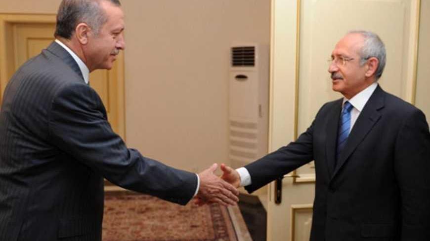 Turkish Prime Minister Recep Tayyip Erdogan shakes hands with main opposition Republican People's Party (CHP) leader Kemal Kilicdaroglu (R) as they meet in Ankara June 24, 2012. Turkey accused Syria on Sunday of shooting down a military plane in international airspace without warning and called a NATO meeting to discuss a response to Syrian President Bashar al-Assad. Amid growing acrimony between the once-friendly neighbours, Syria said its forces had shot dead "terrorists" infiltrating its territory from T