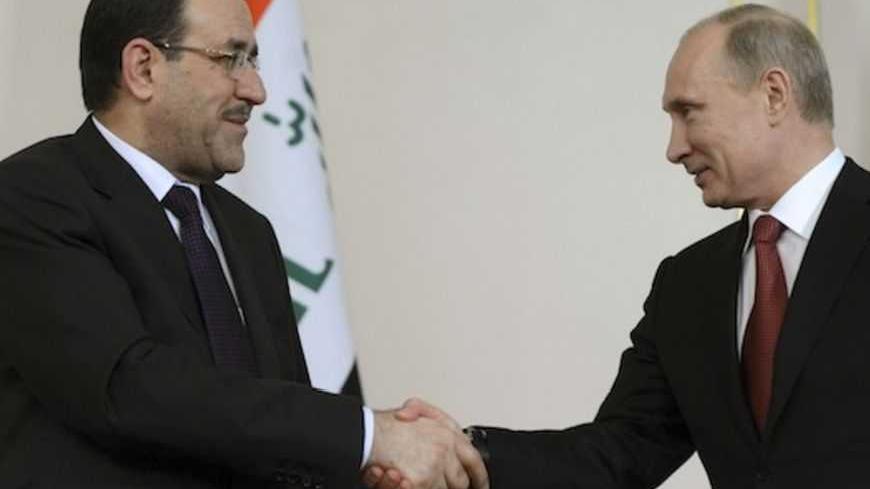 Russian President Vladimir Putin (R) shakes hands with Iraqi Prime Minister Nouri al-Maliki in his Novo-Ogaryovo residence outside Moscow October 10, 2012. Putin lobbied Iraq's prime minister on Wednesday to support Russian energy investment, as the oil arm of gas export monopoly Gazprom pushes for a foothold in the semi-autonomous region of Kurdistan.  REUTERS/Kirril Kudryavtsev/Pool  (RIUSSIA - Tags: POLITICS ENERGY) - RTR38ZTN