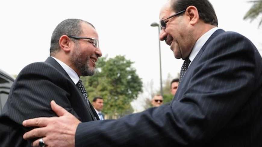 Iraq's Prime Minister Nuri al-Maliki (R) welcomes Egypt's Prime Minister Hisham Qandil during his visit to Baghdad, in this March 4, 2013 picture provided by Iraqi Prime Minister Media Office. REUTERS/Iraqi Prime Minister Media Office/Handout (IRAQ - Tags: POLITICS) ATTENTION EDITORS - THIS IMAGE WAS PROVIDED BY A THIRD PARTY. FOR  EDITORIAL USE ONLY. NOT FOR SALE FOR MARKETING OR ADVERTISING CAMPAIGNS.  THIS PICTURE IS DISTRIBUTED EXACTLY AS RECEIVED BY REUTERS, AS A SERVICE TO CLIENTS - RTR3EK27