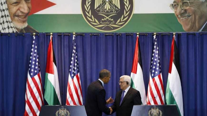 U.S. President Barack Obama and Palestinian President Mahmoud Abbas (R) shake hands at a news conference at the Muqata Presidential Compound in the West Bank City of Ramallah March 21, 2013.     REUTERS/Larry Downing  (WEST BANK - Tags: POLITICS) - RTR3F9ME