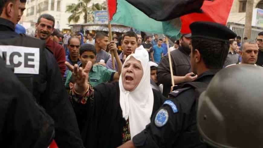 A Palestinian woman argues with policemen during a demonstration against U.S. President Barack Obama's visit to the Church of the Nativity, revered as the site of Jesus' birth, in the West Bank town of Bethlehem March 22, 2013. Obama made a pilgrimage on Friday to the traditional birthplace of Jesus, receiving a subdued reception from Palestinians at the end of a Holy Land visit heavy on symbolism and lacking in practical steps towards peace. REUTERS/Mussa Qawasma (WEST BANK - Tags: POLITICS) - RTR3FBWP