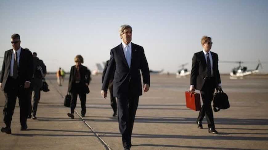 U.S. Secretary of State John Kerry (2nd R) walks across the tarmac of Baghdad International Airport as he prepares to board an aircraft out of the Iraqi capital March 24, 2013. Kerry made an unannounced visit to Iraq on Sunday and said he told Prime Minister Nuri al-Maliki of his concern about Iranian flights over Iraq carrying arms to Syria.   REUTERS/Jason Reed     (IRAQ - Tags: POLITICS) - RTXXVZZ