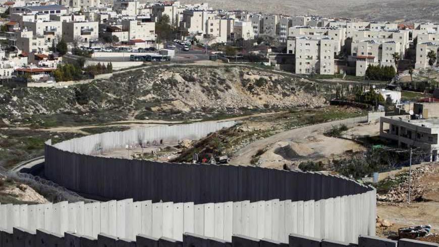 A section of the controversial Israeli barrier is seen between the Shuafat refugee camp (R), in the West Bank near Jerusalem, and Pisgat Zeev (rear), in an area Israel annexed to Jerusalem after capturing it in the 1967 Middle East war, January 27, 2012. Israel has presented Palestinians with its ideas for the borders and security arrangements of a future Palestinian state, in a bid to keep exploratory talks alive, Palestinian and Israeli sources said on Friday. REUTERS/Baz Ratner (JERUSALEM - Tags: POLITIC