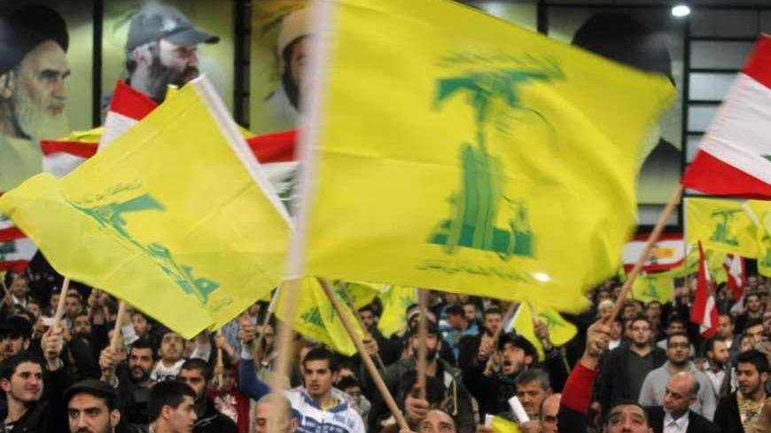 Lebanon's Hezbollah supporters wave flags during a rally to commemorate Martyrs' Day in Beirut, February 16, 2013. REUTERS/Sharif Karim (LEBANON - Tags: POLITICS) - RTR3DVBY
