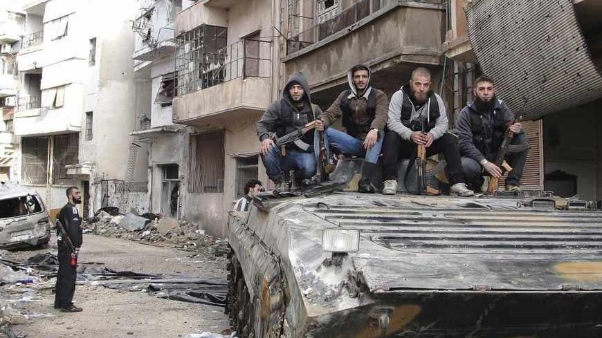 Free Syrian Army fighters pose for a picture on a tank, that they claim to have seized from the Syrian Regime forces, in Homs April 5, 2013 in this picture provided by Shaam News Network. Picture taken April 5, 2013. REUTERS/Mohamed Ibrahim/Shaam News Network/Handout (SYRIA - Tags: POLITICS CIVIL UNREST CONFLICT MILITARY)

ATTENTION EDITORS - THIS PICTURE WAS PROVIDED BY A THIRD PARTY. REUTERS IS UNABLE TO INDEPENDENTLY VERIFY THE AUTHENTICITY, CONTENT, LOCATION OR DATE OF THIS IMAGE. THIS PICTURE IS DISTRI