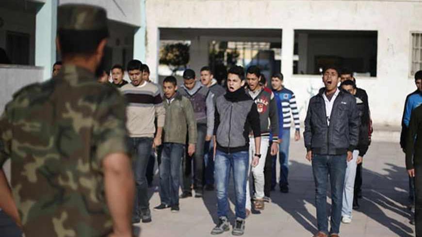 Palestinian students take part in a military-style exercise at the courtyard of a high school in Khan Younis in the southern Gaza Strip March 6, 2013. The military-style exercise in the 138 Hamas-run high schools in Gaza was part of a program sanctioned by the Hamas Islamist government to teach students how to use guns. Education officials in Gaza say some 6,000 students have joined the training initiative where only boys can sign up for the voluntary program in and they need their parents' permission to jo