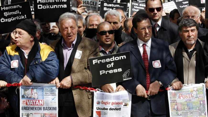 Journalists and activists participate in a rally calling for press freedom in central Ankara March 19, 2011. The recent arrest and jailing of some 10 journalists as part of investigations into Ergenekon, an ultra-nationalist, secularist network opposed to Prime Minister's Tayyip Erdogan's rule, has a triggered expressions of concern from the European Union, the U.S. and human rights groups about Ankara's commitment to media freedom and democratic principles.  REUTERS/Umit Bektas (TURKEY - Tags: CIVIL UNREST