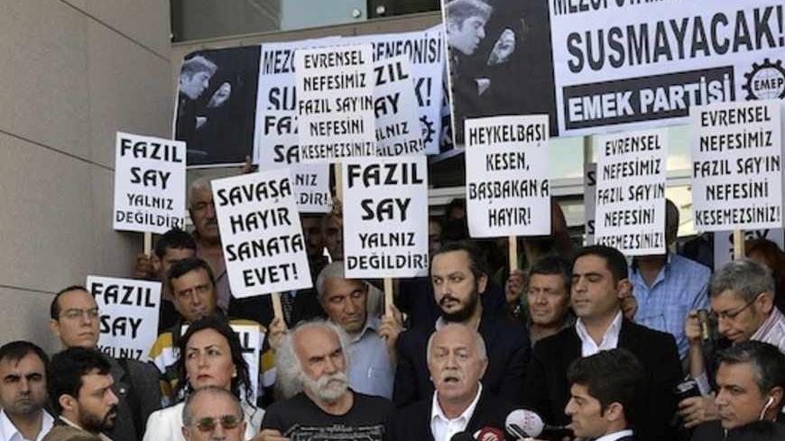 Supporters of Turkish classical pianist Fazil Say demonstrate in front of the court house in Istanbul October 18, 2012. Internationally acclaimed Turkish classical pianist Fazil Say goes on trial on charges of insulting Muslim religious values in comments posted on Twitter.  REUTERS/Burak Akbulut/Anadolu Agency (TURKEY - Tags: POLITICS CIVIL UNREST CRIME LAW) FOR EDITORIAL USE ONLY. NOT FOR SALE FOR MARKETING OR ADVERTISING CAMPAIGNS. THIS IMAGE HAS BEEN SUPPLIED BY A THIRD PARTY. IT IS DISTRIBUTED, EXACTLY