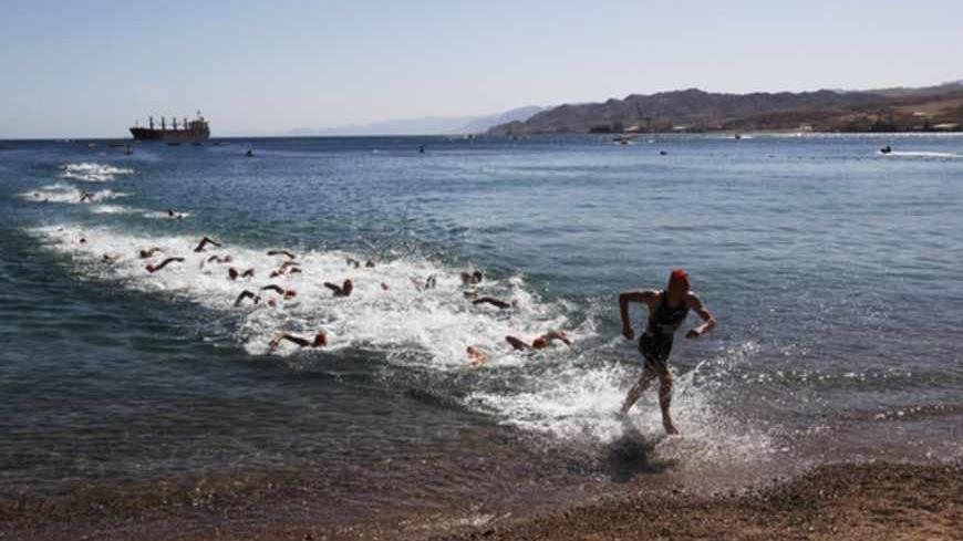 A triathlete runs out of the Red Sea during the Elite Men's Triathlon ETU European Championships in the southern Israeli city of Eilat April 21, 2012. Picture taken April 21, 2012. REUTERS/Ronen Zvulun (ISRAEL - Tags: SPORT TRIATHLON TPX IMAGES OF THE DAY) - RTR3BK4J