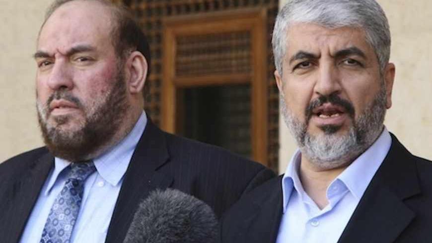 Hamas leader Khaled Meshaal (R) and Mohammad Nazzal, a member of the Hamas leadership, speak to media after their meeting with Jordan's King Abdullah at the Royal Palace in Amman January 28, 2013.  REUTERS/Majed Jaber (JORDAN - Tags: POLITICS) - RTR3D30A