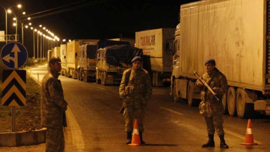 Turkish soldiers block a road to Cilvegozu border gate near the town of Reyhanli on the Turkish-Syrian border in Hatay province February 11, 2013. A Syrian minibus exploded at Cilvegozu border post on Turkey's border with Syria near the Turkish town of Reyhanli on Monday, killing at least 13 people including Turkish citizens and wounding dozens more, Turkish officials said. REUTERS/Umit Bektas (TURKEY - Tags: POLITICS CIVIL UNREST DISASTER) - RTR3DNGS