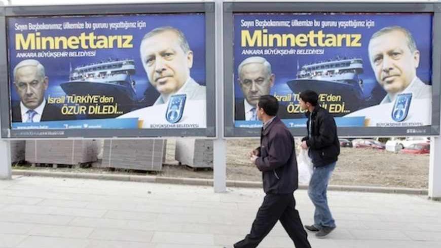 Pedestrians look at billboards with the pictures of Turkey's Prime Minister Tayyip Erdogan (R) and his Israeli counterpart Benjamin Netanyahu (L), in Ankara March 25, 2013. Turkey's Prime Minister Tayyip Erdogan said on Saturday an Israeli apology for the 2010 deaths of nine Turkish pro-Palestinian activists that was brokered by U.S. President Barack Obama met Turkey's conditions and signalled its growing regional clout. The billboard reads, "Israel apologized to Turkey. Dear Prime Minister (Erdogan), We ar