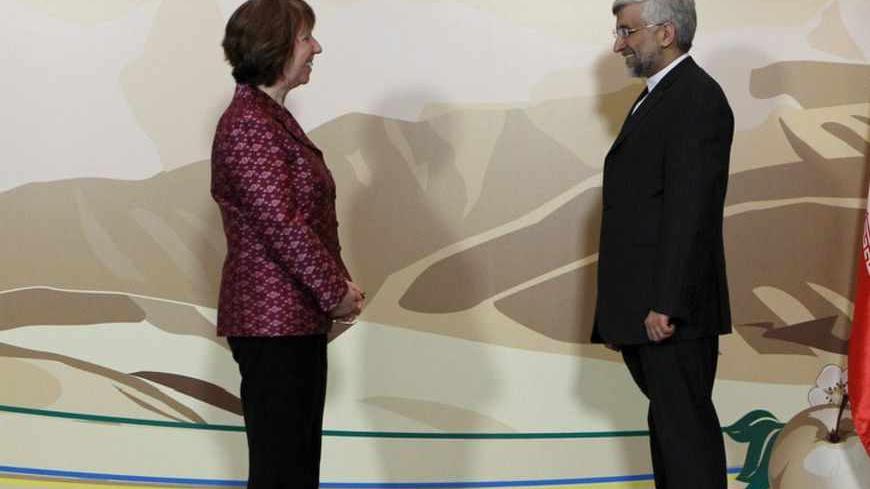 Iran's Chief negotiator Saeed Jalili (R) and European Union Foreign Policy chief Catherine Ashton stand for a photograph before talks in Almaty April 5, 2013. World powers will urge Iran on Friday to accept their offer to ease some economic sanctions if it stops its most sensitive nuclear work, in talks aimed at easing tensions that threaten to boil over into war. REUTERS/Shamil Zhumatov (KAZAKHSTAN - Tags: POLITICS) - RTXY95M