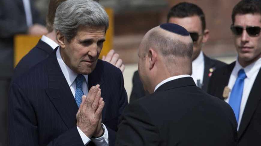 U.S. Secretary of State John Kerry (L) greets an Israeli official before a wreath-laying ceremony marking Israel's annual day of Holocaust remembrance, at Yad Vashem in Jerusalem April 8, 2013. Israel on Monday commemorates the six million Jews killed by the Nazis in the Holocaust during World War Two. REUTERS/Ronen Zvulun (JERUSALEM - Tags: POLITICS ANNIVERSARY CONFLICT TPX IMAGES OF THE DAY) - RTXYD4T