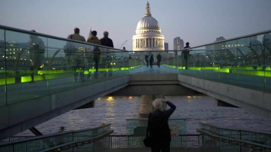 Tourists walk across the Millennium Bridge near the Tate Modern in London March 12, 2012.  London will host the Olympics Games this summer. Picture taken March 12, 2012.     REUTERS/Kieran Doherty    (BRITAIN - Tags: TRAVEL CITYSPACE SPORT OLYMPICS) ATTENTION EDITORS - PICTURE 2 OF 20 FOR PACKAGE 'SCENIC LONDON 2012' - RTR2ZWN2