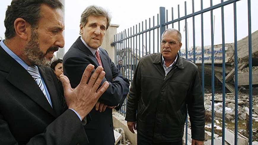 U.S. Senator John Kerry (D-MA) listens to a Palestinian man during his visit to the destroyed American International School in the northern Gaza Strip February 19, 2009. Senator Kerry and two other lawmakers made a rare visit to the Gaza Strip on Thursday but insisted a boycott of its Hamas Islamist rulers remained intact.Senate Foreign Relations Committee Chairman Kerry, who ran an unsuccessful campaign for president in 2004, and two members of the House of Representatives, Brian Baird and Keith Ellison, e