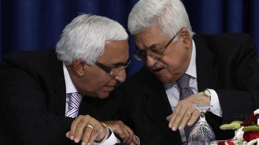 Palestinian President Mahmoud Abbas (R) speaks to Moshe Shahal, a member of the Israel Peace Initiative and a former Israeli cabinet minister, during a news conference after Abbas met members of the Israeli Peace Initiative in the West Bank city of Ramallah April 28, 2011. The Israel Peace Initiative, a private group that includes former politicians and security officials, wants Israeli Prime Minister Benjamin Netanyahu's government to renew peace talks, which the Palestinians have frozen over his refusal t