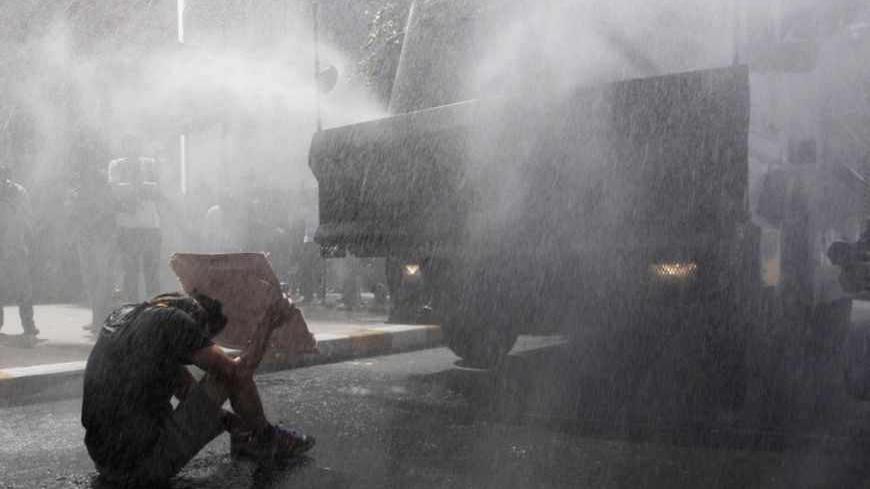 Turkish riot police use water cannon to disperse demonstrators during a protest against the destruction of trees in a park brought about by a pedestrian project, in Taksim Square in central Istanbul May 31, 2013. REUTERS/Osman Orsal (TURKEY - Tags: POLITICS CIVIL UNREST ENVIRONMENT CRIME LAW TPX IMAGES OF THE DAY) - RTX106X6