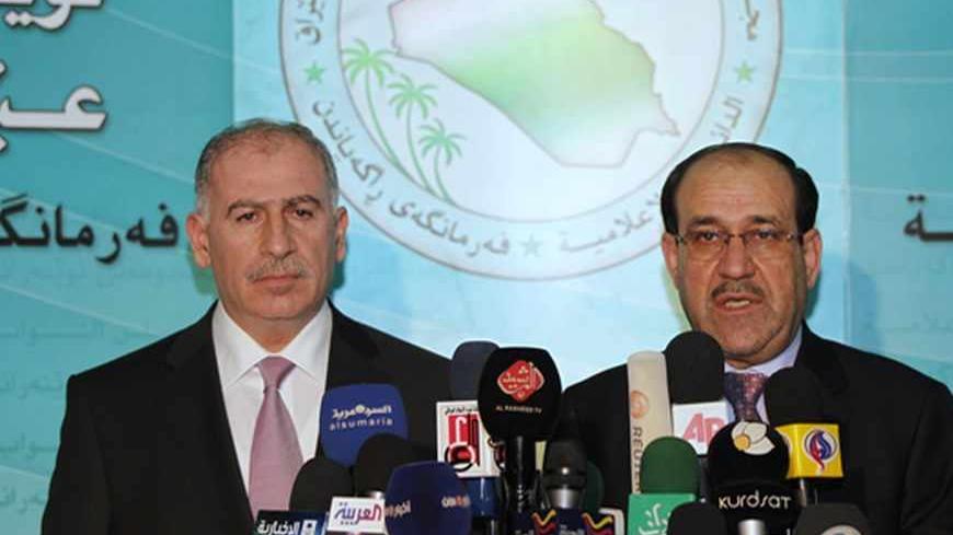 Iraq's Prime Minister Nuri al-Maliki (R) speaks during a joint news conference with Iraqi parliament speaker Osama al-Nujaifi in Baghdad December 20, 2010. REUTERS/Mohammed Ameen (IRAQ - Tags: POLITICS) - RTXVWR8