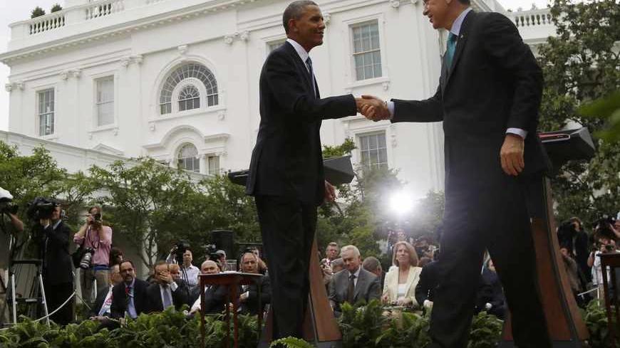 U.S. President Barack Obama and Turkey's Prime Minister Recep Tayyip Erdogan (R) shake hands at the end of their joint news conference in the Rose Garden of the White House in Washington, May 16, 2013.     REUTERS/Jason Reed    (UNITED STATES - Tags: POLITICS) - RTXZPEK