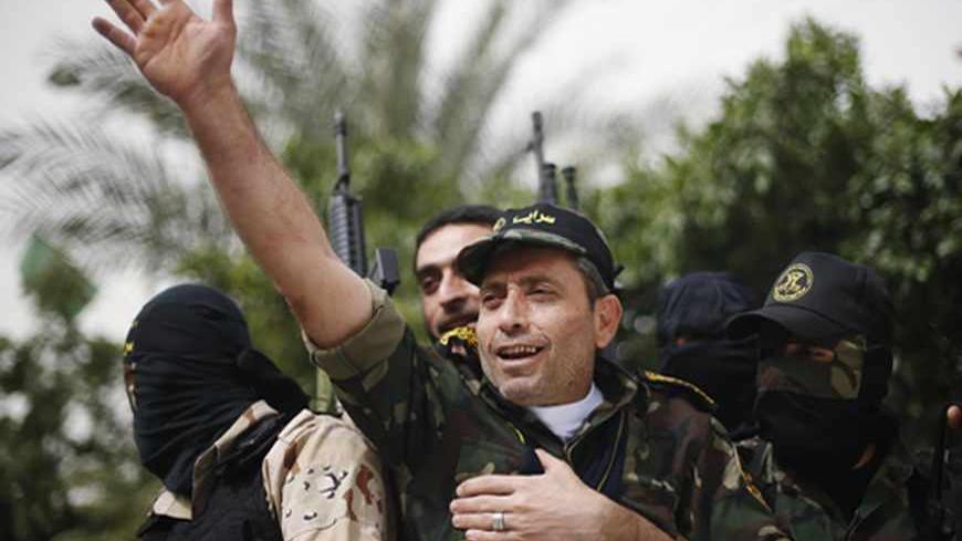 Freed Palestinian prisoner Ibrahim Baroud waves upon his arrival in Gaza City April 8, 2013. Baroud, who was convicted of his affiliation with the armed group of Islamic Jihad and for carrying out armed attacks against Israel, was released on Monday after serving 27 years in an Israeli jail, according to media reports.  REUTERS/Mohammed Salem (GAZA - Tags: POLITICS) - RTXYD5M