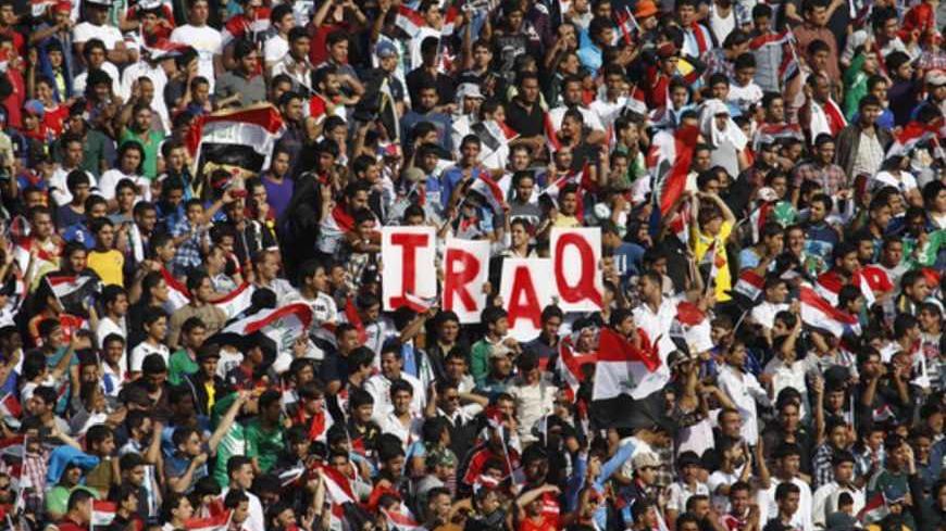 Iraq's fans hold up placards during the team's international friendly soccer match against Syria at Baghdad's Shaab stadium March 26, 2013. Iraq will be allowed to play friendly matches at home again following approval from soccer's world governing body FIFA on Thursday. Iraq were banned from playing all games at home for security reasons after losing a World Cup qualifier 2-0 to Jordan at the Franso Hariri Stadium in Arbil in September 2011. The reprieve does not apply to World Cup qualifiers for which Ira