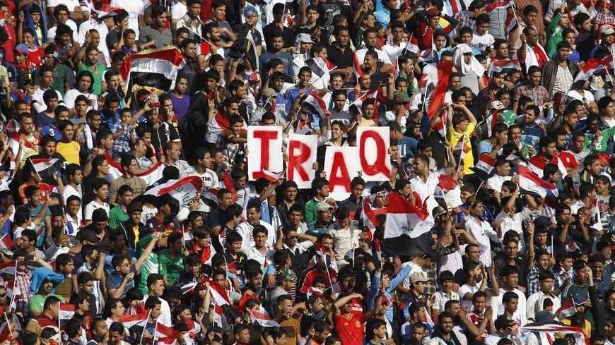 Iraq's fans hold up placards during the team's international friendly soccer match against Syria at Baghdad's Shaab stadium March 26, 2013. Iraq will be allowed to play friendly matches at home again following approval from soccer's world governing body FIFA on Thursday. Iraq were banned from playing all games at home for security reasons after losing a World Cup qualifier 2-0 to Jordan at the Franso Hariri Stadium in Arbil in September 2011. The reprieve does not apply to World Cup qualifiers for which Ira