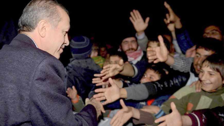 Turkish Prime Minister Tayyip Erdogan shakes hands with Syrian refugees as he visits a refugee camp near Akcakale border crossing on the Turkish-Syrian border, southern Sanliurfa province, December 30, 2012. REUTERS/Kayhan Ozer/Prime Minister's Press Office/Handout (TURKEY - Tags: POLITICS CONFLICT) FOR EDITORIAL USE ONLY. NOT FOR SALE FOR MARKETING OR ADVERTISING CAMPAIGNS. THIS IMAGE HAS BEEN SUPPLIED BY A THIRD PARTY. IT IS DISTRIBUTED, EXACTLY AS RECEIVED BY REUTERS, AS A SERVICE TO CLIENTS - RTR3BZG7