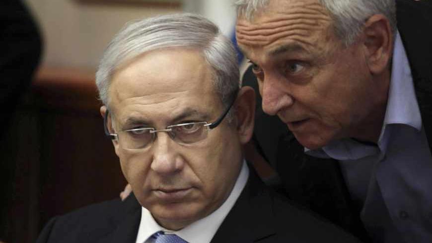 Israel's Prime Minister Benjamin Netanyahu (L) listens to Internal Security Minister Yitzhak Aharonovitch at the start of the weekly cabinet meeting in Jerusalem May 8, 2011. REUTERS/Gali Tibbon/Pool (JERUSALEM - Tags: POLITICS IMAGES OF THE DAY) - RTR2M4VF