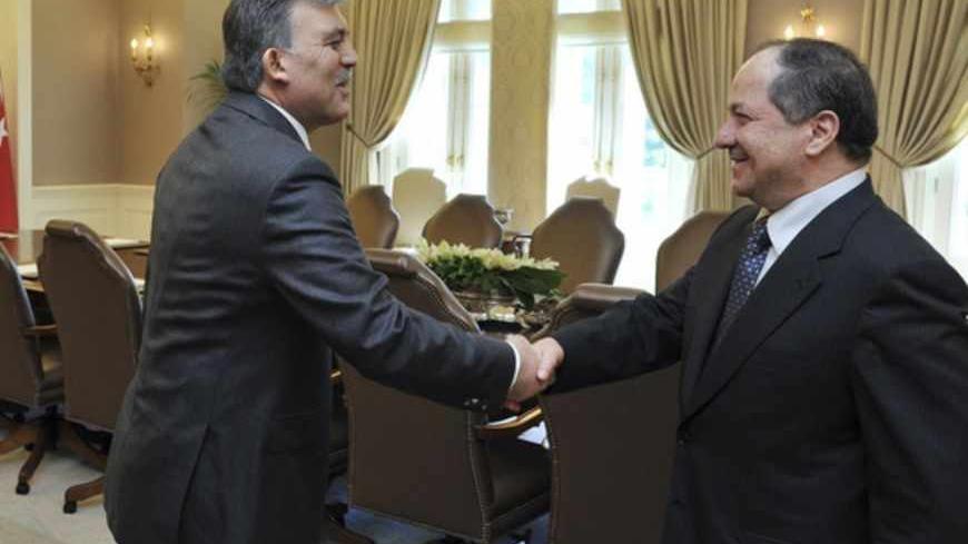 Turkish President Abdullah Gul (L) and Kurdistan Region President Masoud Barzani shake hands before their meeting at the Presidential Palace in Ankara April 20, 2012. REUTERS/Presidential Palace/Murat Cetinmuhurdar/Handout (TURKEY - Tags: POLITICS) FOR EDITORIAL USE ONLY. NOT FOR SALE FOR MARKETING OR ADVERTISING CAMPAIGNS. THIS IMAGE HAS BEEN SUPPLIED BY A THIRD PARTY. IT IS DISTRIBUTED, EXACTLY AS RECEIVED BY REUTERS, AS A SERVICE TO CLIENTS - RTR30ZAR