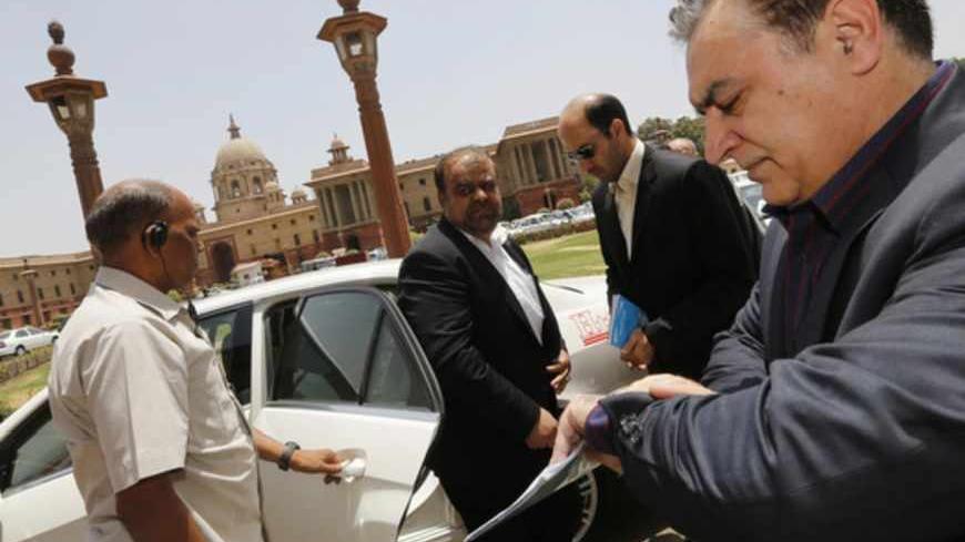 Iran's Oil Minister Rostam Qasemi (C) arrives to attend a meeting with India's Finance Minister Palaniappan Chidambaram (not seen) in New Delhi May 28, 2013. Iran has offered insurance to Indian refiners in a bid to boost its crude sales, industry sources said, though some oil executives warned the plan would not remove the threat of western sanctions. The offer was made during a visit to India led by Qasemi in a bid to revive crude sales from its second-largest customer. REUTERS/Adnan Abidi (INDIA - Tags: 