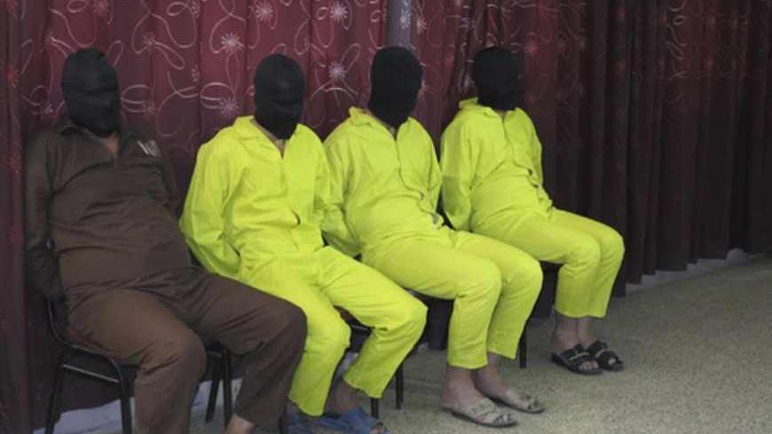 Detainees suspected of being part of an armed cell with links to al Qaeda are shown to the media during a news conference at the Defence Ministry in Baghdad June 1, 2013. The four men are accused of planning to make chemical weapons like nerve and mustard gas, according to the ministry.                           REUTERS/Stringer (IRAQ - Tags: CIVIL UNREST CRIME LAW POLITICS) - RTX10827