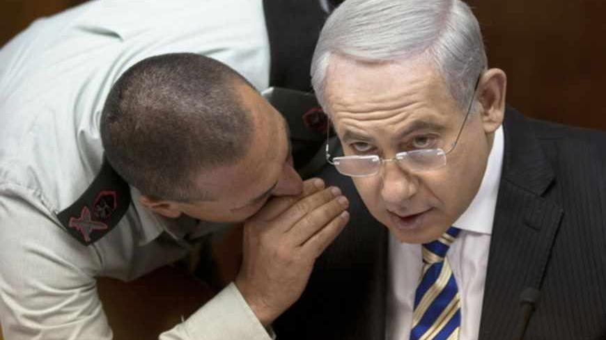 Israel's Prime Minister Benjamin Netanyahu (R) listens to his aide-de-camp Eyal Zamir during the weekly cabinet meeting in Jerusalem June 2, 2013. REUTERS/Sebastian Scheiner/Pool (JERUSALEM - Tags: POLITICS) - RTX108W1