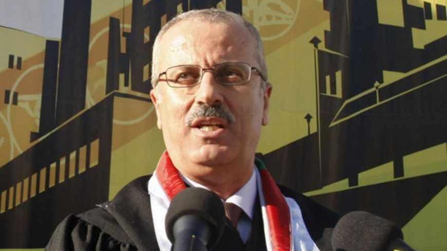 Rami Hamdallah, President of al-Najah National University, speaks during a graduation ceremony at the university in the West Bank city of Nablus June 16, 2011. Palestinian President Mahmoud Abbas named British-educated political independent Hamdallah as new prime minister on June 2, 2013, a move that was immediately condemned by Gaza Strip rulers Hamas. Picture taken June 16, 2011.  REUTERS/Abed Omar Qusini  (WEST BANK  - Tags: POLITICS EDUCATION) - RTX109UY