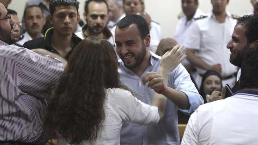 Friends of Egyptian suspects react after hearing the judge's verdict at a court room during a case against foreign non-governmental organisations (NGOs) in Cairo June 4, 2013. An Egyptian court sentenced at least 15 U.S. citizens in absentia to five years in jail on Tuesday and one American who stood trial was jailed for two years in a case against private foreign groups seeking to promote democracy.  Judge Makram Awad also ordered the closure of the NGOs, including the U.S.-based International Republican I