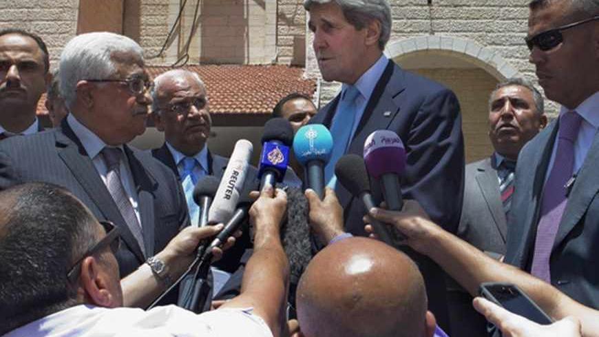 U.S. Secretary of State John Kerry (C), with Palestinian President Mahmoud Abbas (L), makes a short statement to the media after their meeting in the West Bank town of Ramallah June 30, 2013. Kerry ended a shuttle diplomacy mission on Sunday without an agreement on resuming Israeli-Palestinian peace talks but said gaps had been narrowed and he would return to the region soon. REUTERS/Jacquelyn Martin/Pool (WEST BANK - Tags: POLITICS) - RTX116U7
