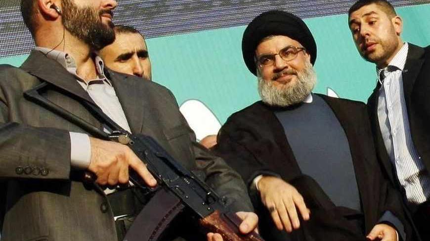 Lebanon's Hezbollah leader Sayyed Hassan Nasrallah (2nd R), escorted by his bodyguards, greets his supporters at an anti-U.S. protest in Beirut's southern suburbs, in this September 17, 2012 file photo. European Union governments agreed on July 22, 2013 to put the armed wing of Hezbollah on the EU terrorism blacklist in a reversal of past policy fuelled by concerns over the Lebanese militant movement's activities in Europe. REUTERS/Sharif Karim/Files (LEBANON - Tags: POLITICS CIVIL UNREST) - RTX11UWC