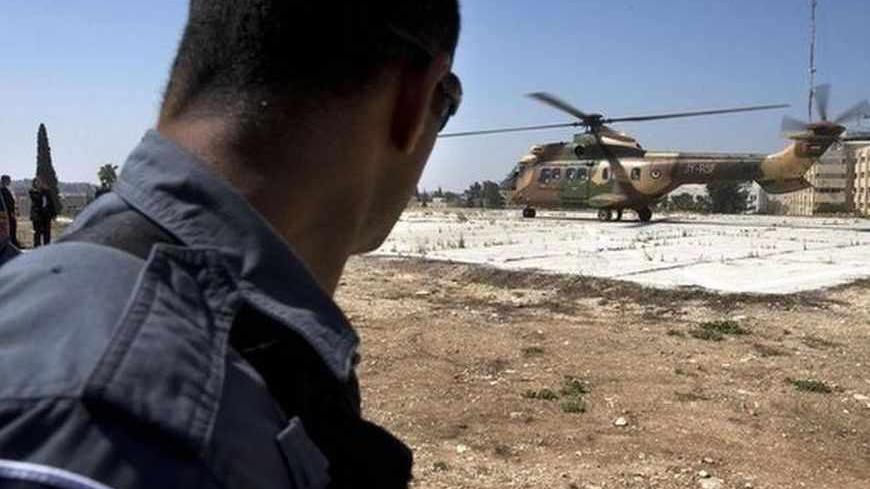 An Israeli security forces member stands by as a Jordanian helicopter starts to lift off to take U.S. Secretary of State John Kerry to Amman, in Jerusalem, June 29, 2013. Kerry was bound for a meeting with Palestinian President Mahmoud Abbas in Amman, Jordan.  REUTERS/Jacquelyn Martin/Pool (JERUSALEM - Tags: POLITICS) - RTX115RJ
