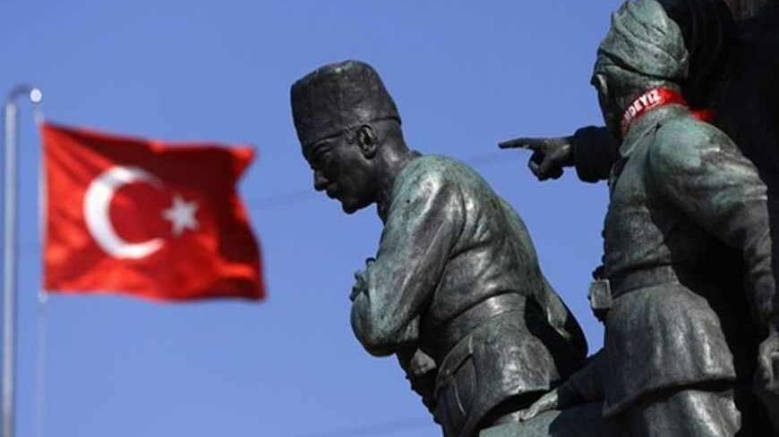 A Turkish flag flutters near the monument of Mustafa Kemal Ataturk at Taksim Square in Istanbul June 24, 2013. REUTERS/Marko Djurica (TURKEY - Tags: SOCIETY) - RTX10Z87