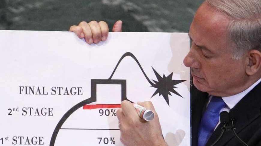Israel's Prime Minister Benjamin Netanyahu draws a red line on the graphic of a bomb used to represent Iran's nuclear program as he addresses the 67th United Nations General Assembly at the U.N. Headquarters in New York, September 27, 2012. The red line he drew represents a point where he believes, the international community should tell Iran that they will not be allowed to pass without intervention. REUTERS/Lucas Jackson (UNITED STATES - Tags: POLITICS) - RTR38I7P