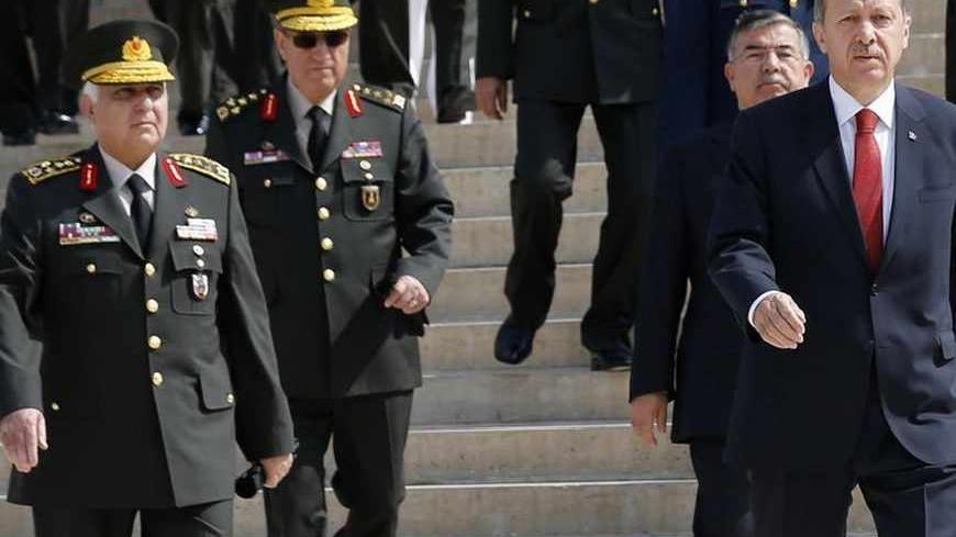 Turkey's Prime Minister Tayyip Erdogan (C) leaves after a wreath-laying ceremony with members of the High Military Council at the mausoleum of Mustafa Kemal Ataturk, founder of modern Turkey, in Ankara August 1, 2013. REUTERS/Umit Bektas (TURKEY - Tags: MILITARY POLITICS) - RTX126OH