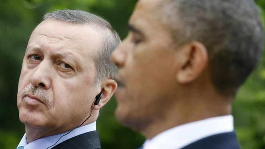 Turkish Prime Minister Recep Tayyip Erdogan (L) listens to U.S. President Barack Obama during a joint news conference in the White House Rose Garden in Washington, May 16, 2013.  REUTERS/Kevin Lamarque (UNITED STATES  - Tags: POLITICS)   - RTXZPB1