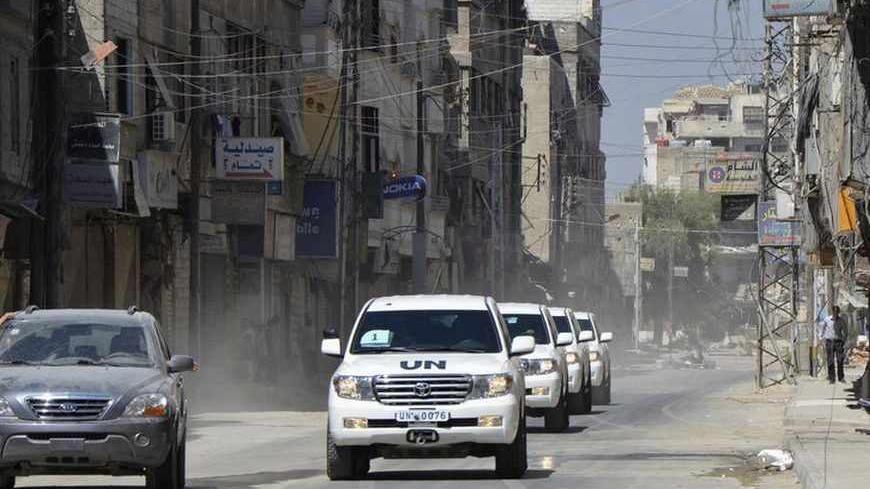 A convoy of U.N. vehicles carrying a team of United Nations chemical weapons experts and escorted by Free Syrian Army fighters (vehicle on left) drive through one of the sites of an alleged chemical weapons attack in eastern Ghouta in Damascus suburbs August 28, 2013. A team of United Nations inspectors reached rebel-held territory outside Damascus on Wednesday, opposition activists said, and would soon begin a second day of investigating the sites of an alleged chemical weapons attack that killed hundreds 