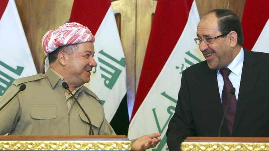 Iraqi Prime Minister Nuri al-Maliki (R) and Iraqi Kurdish President Masoud Barzani (L) talk as they hold a joint news conference in Baghdad, July 7, 2013. Barzani visited Baghdad on Sunday for the first time in more than two years, in a symbolic step to resolve disputes between the central government and the autonomous region over land and oil. The visit follows an equally rare trip by Iraqi Prime Minister Nuri al-Maliki who met Barzani in Kurdistan last month, breaking ice between leaders who have repeated