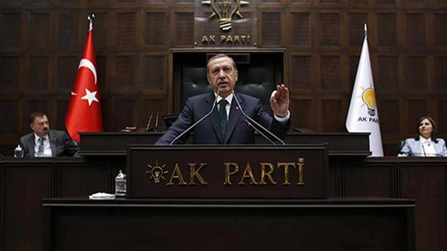 Turkey's Prime Minister Tayyip Erdogan addresses members of parliament from his ruling AK Party (AKP) during a meeting at the Turkish parliament in Ankara June 11, 2013. Erdogan called on protesters to withdraw from central Istanbul's Gezi Park on Tuesday and said the anti-government demonstrations were part of a deliberate attempt to damage Turkey's image and economy. REUTERS/Umit Bektas (TURKEY - Tags: POLITICS CIVIL UNREST) - RTX10JI0