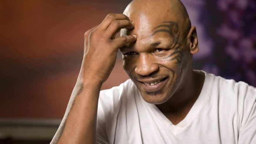 Former undisputed heavyweight boxing champion Mike Tyson thinks over a question during an interview at the MGM Grand Hotel and Casino in Las Vegas, Nevada March 23, 2012. Tyson has, in his own words, behaved like a "Neanderthal" for much of his life. But next month, he hopes to become a "controlled artist, a disciplined artist" when he takes to a Las Vegas stage to talk about his checkered life as a childhood thief, an ear-biting fighter, an addict and a father of eight. Tyson, who in 1986 became the younge