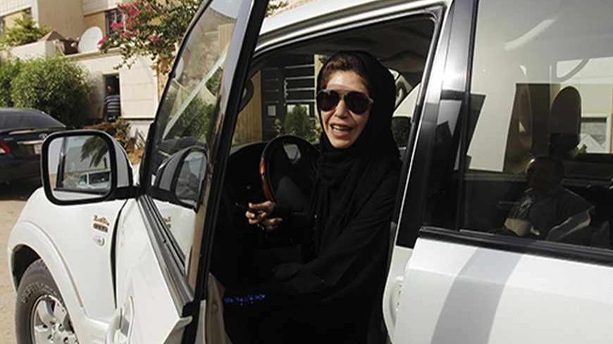 Female driver Azza Al Shmasani alights from her car after driving in defiance of the ban in Riyadh June 22, 2011. Saudi Arabia has no formal ban on women driving. But as citizens must use only Saudi-issued licences in the country, and as these are issued only to men, women drivers are anathema. An outcry at the segregation, which contributes to the general cloistering of Saudi women, has been fuelled by social media interest in two would-be female motorists arrested in May.REUTERS/Fahad Shadeed   (SAUDI ARA